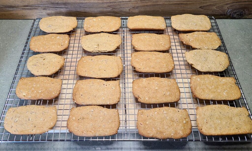 20 old fashioned simple brown sugar Clifford tea cookies cooling on a large wire rack.
