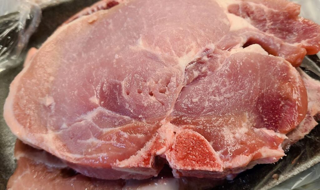 Raw pork chop to make simple low carb baked and broiled juicy pork chops.