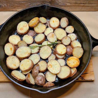 cast iron pan with roasted potatoes