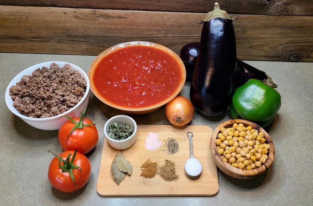 Ingredients to make Simple Lebanese chickpea and beef moussaka (maghmour) artfully arranged on the counter. 