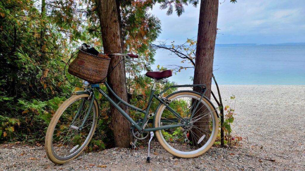 Bike on a biking trail with the lake behind it as part of 48 awesome and inexpensive staycation ideas for families.
