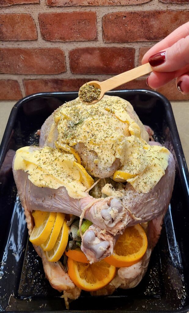 Putting herbs on a terrific roasted French turkey with champagne and herbs .