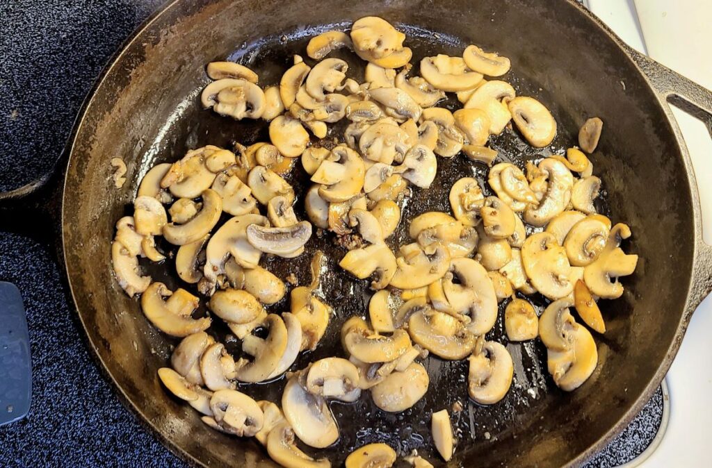 Cooking mushrooms in a cast iron skillet. 