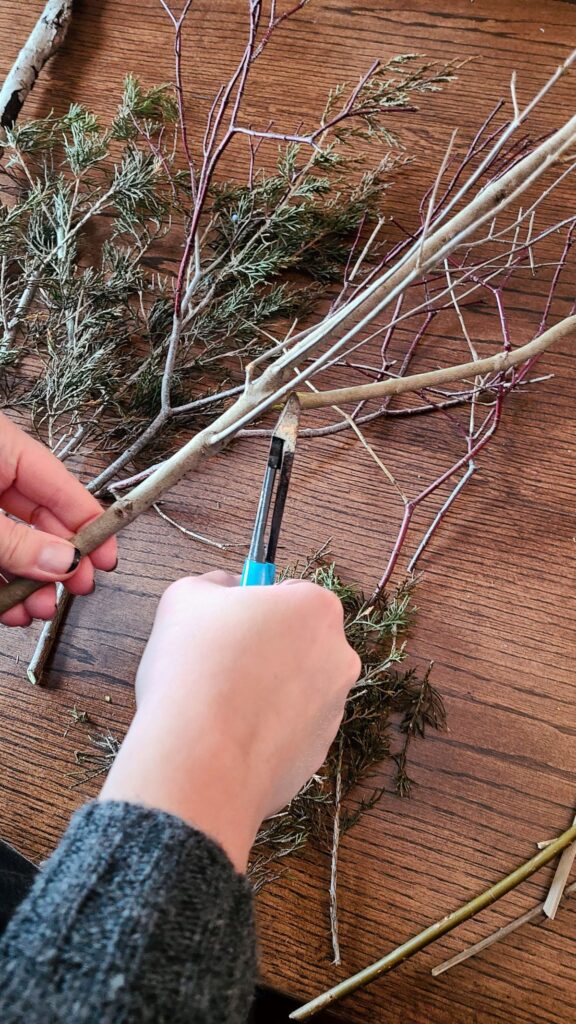 Trimming a branch at a table. 
