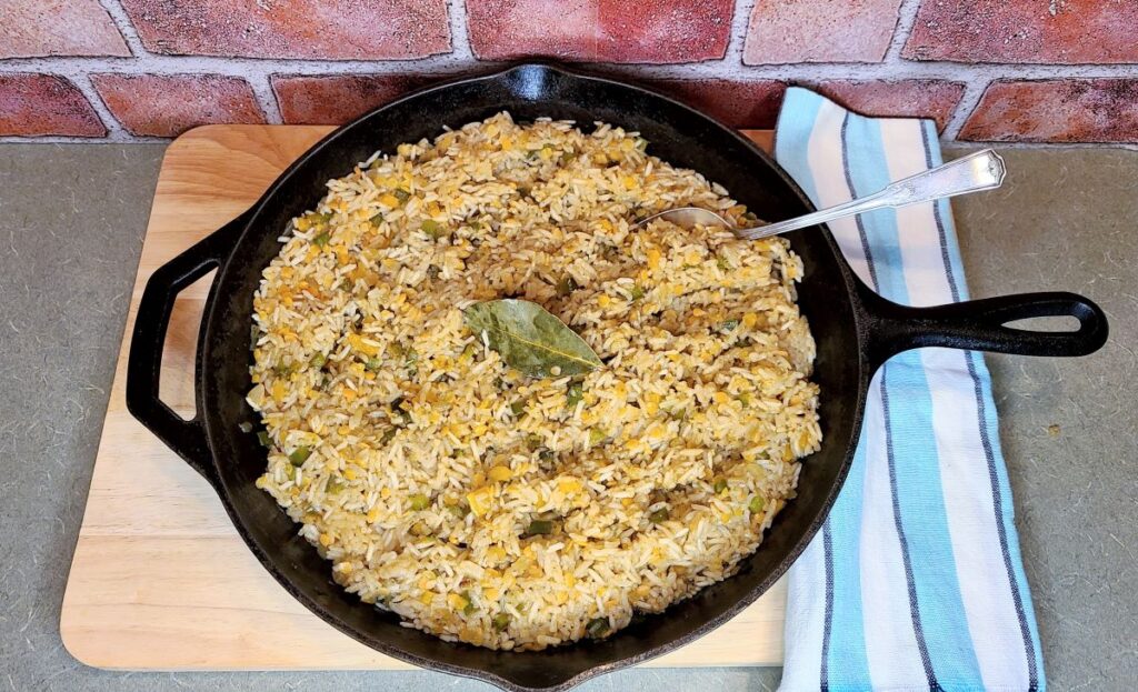What are the best things that go with dirty rice in a skillet with a blue towel.