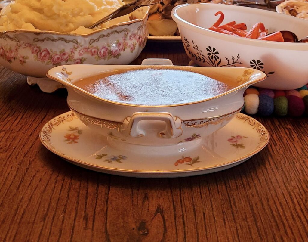 Pretty china gravy boat with delicious gravy from the juices of a terrific roasted French turkey with champagne and herbs.