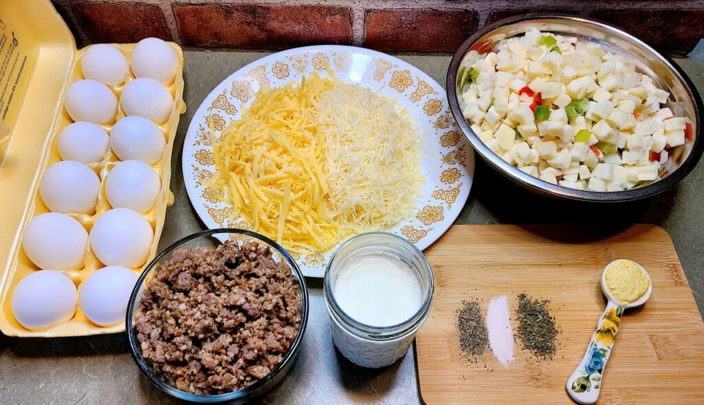 Ingredients to make Easy overnight sausage, egg, & potato breakfast casserole set out. 