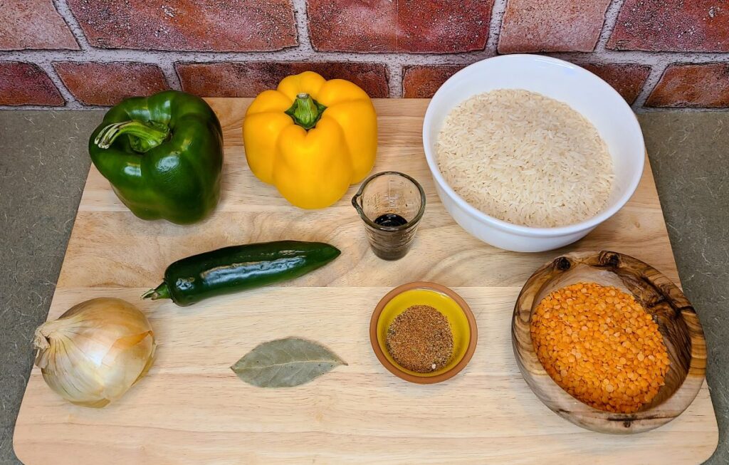 Ingredients to make dirty rice on a wood board.