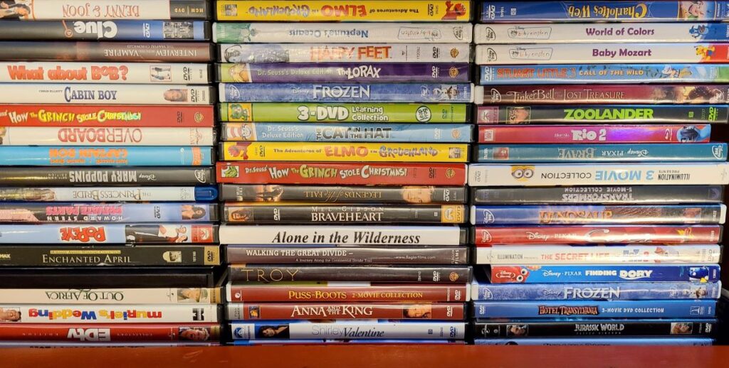 Stacks of DVDs for movies night as part of 48 awesome and inexpensive staycation ideas for families.