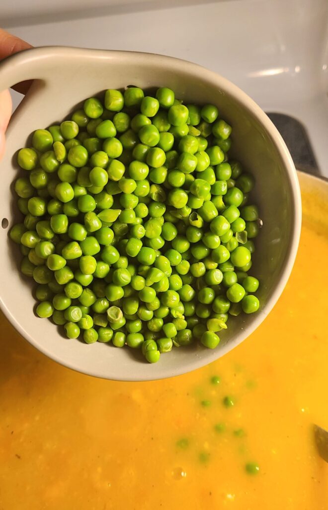 Putting peas into soup. 