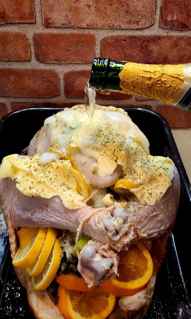 Pouring champagne over a turkey before roasting. 